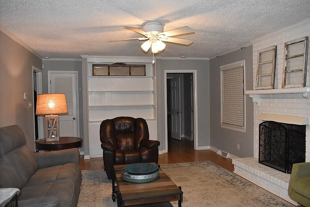 4509 Doncaster Dr - Family Room Painted Brick Fireplace, Coat Closet, Built-In Shelving, and Wood Floors